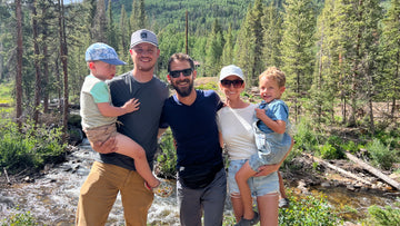 Nut Ruck Founders and their families standing in front of a river in a pine forrest in the mountains